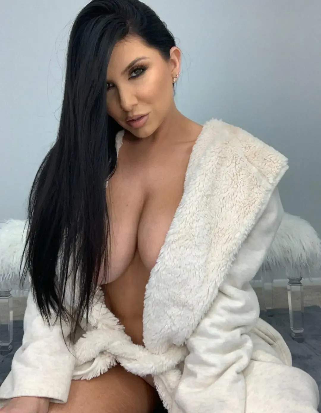 1girl, female only, white female, breasts, looking at viewer, female, long hair, indoors, straight hair, big breasts, makeup, black hair, sitting, bedroom, dark hair, earrings