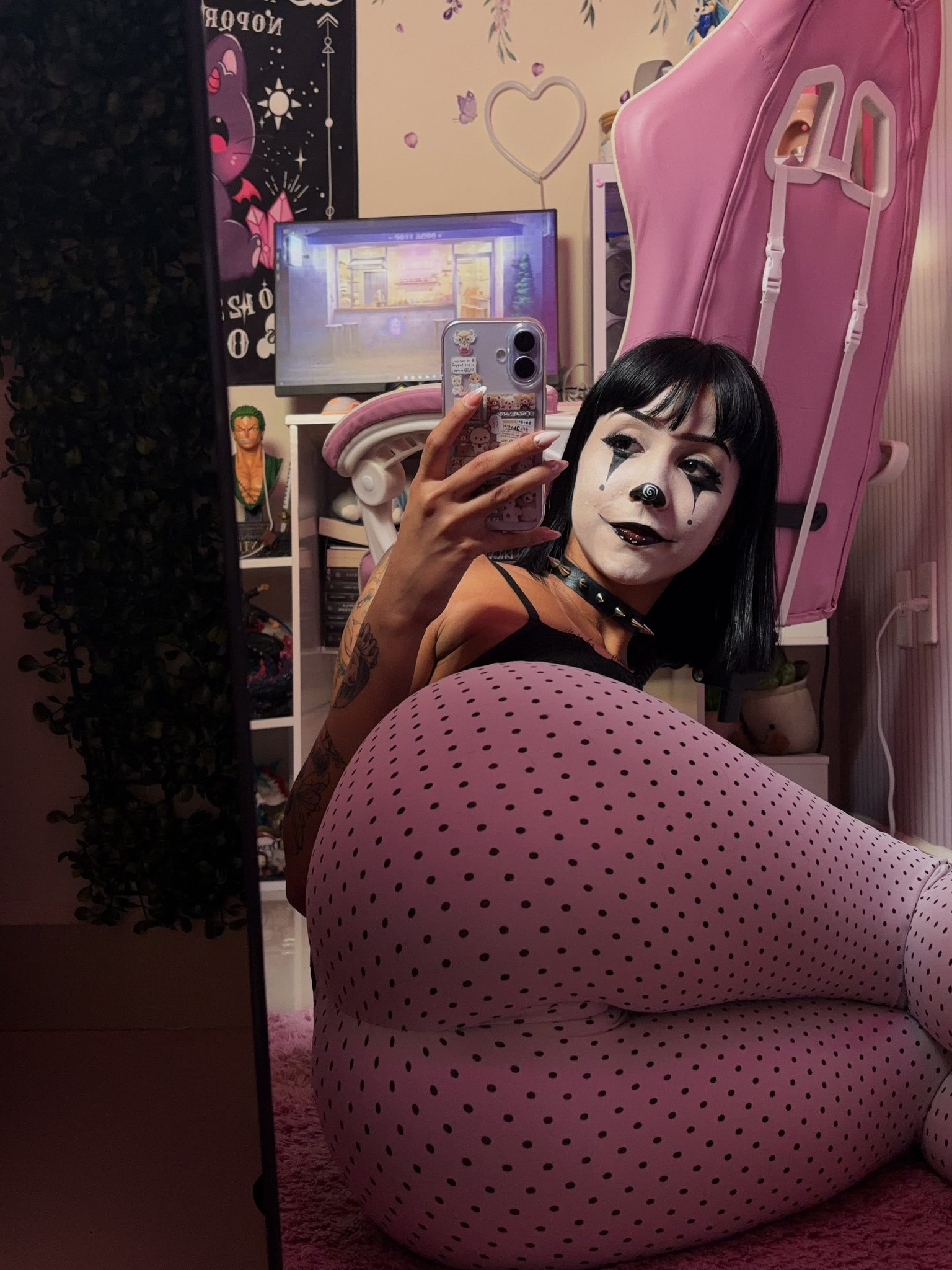 skylecherry, skylewaifu, 1girl, female only, caucasian female, medium hair, ass, straight hair, selfie, black hair, rear view, fringe, tattoos, bangs, non-nude, clothed, from behind, legs together, mirror selfie, on floor, on side, collar, cameltoe, spiked collar, clown, clown girl, facepaint, leggins