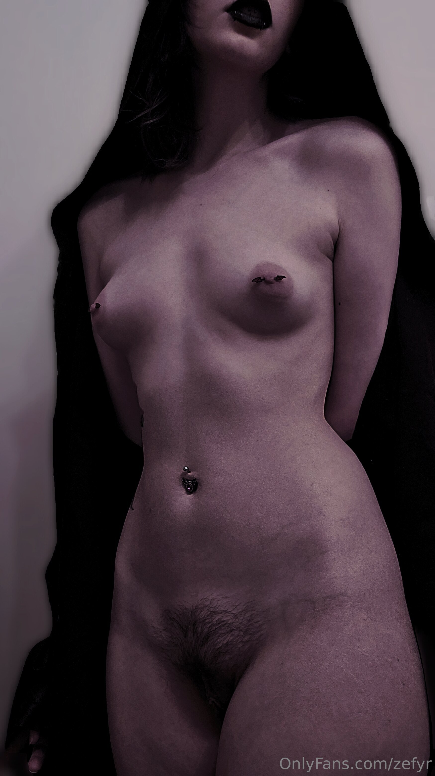 zefyr, 1girl, female only, white female, breasts, nipples, areolae, medium hair, standing, piercing, black hair, small breasts, tattoos, breasts apart, stomach, pale skin, watermark, pale, nipple piercing, onlyfans, pubic hair, midriff, navel piercing, hips, waist, black lipstick, puffy nipples, bush, arms behind back