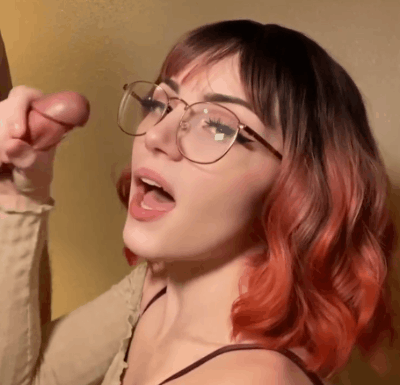 1girl, white female, medium hair, brown hair, light-skinned female, makeup, pale-skinned female, fringe, dyed hair, penis, clothed, 1boy, pale, red hair, tongue out, cum, multicolored hair, eyeliner, glasses, open mouth, gif, curly hair, cum on face, ejaculation, gradient hair, orange hair, facial, cum on hair, faceless male, handjob